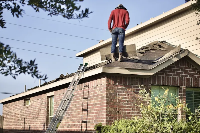 Professional roofer working on a residential roof in Gages Lake